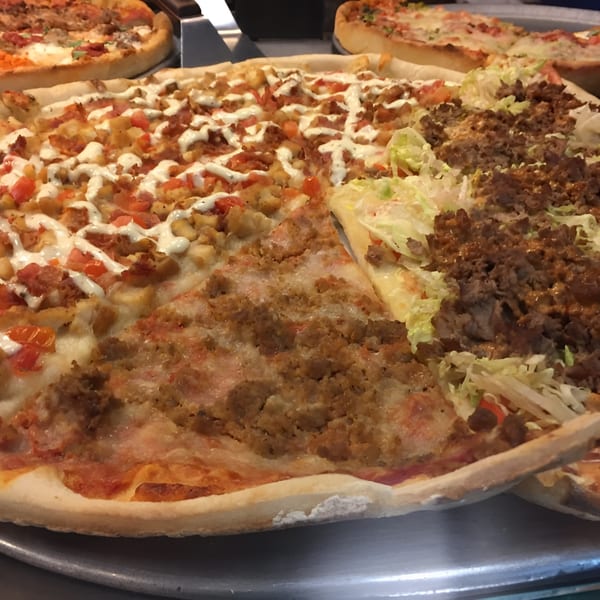 Aljon's Grill Pizzeria offers a large pizza with three distinct toppings: chicken, ground meat, and kebab.