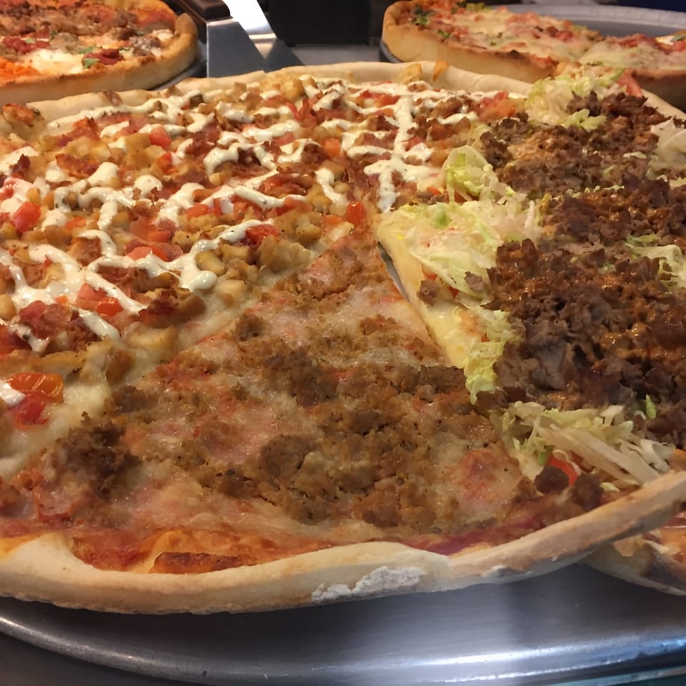 Aljon's Grill Pizzeria offers a large pizza with three distinct toppings: chicken, ground meat, and kebab.